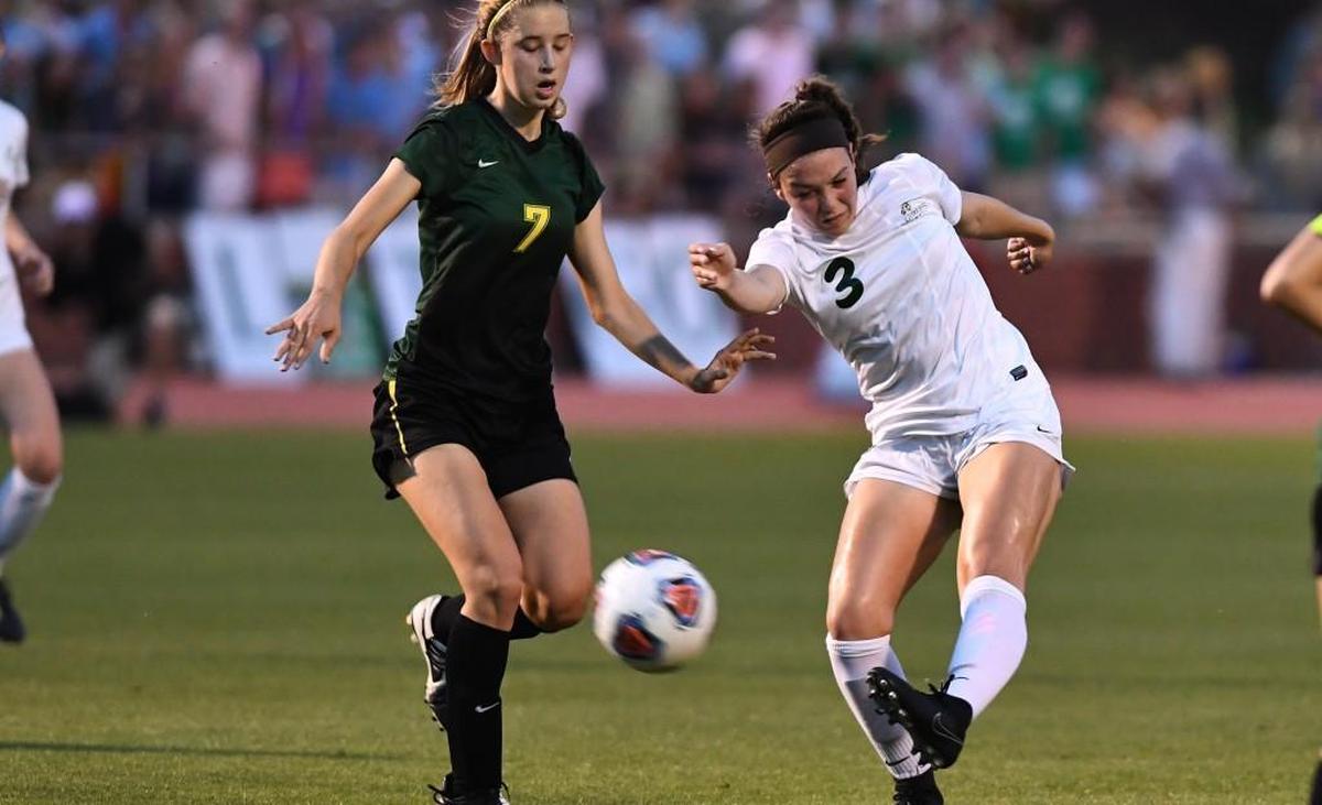 Haley Garrett (3) of Cardinal Gibbons takes a shot against Bri Hudnall (7) of West Forsyth. The Cardinal Gibbons Crusaders played the West Forsyth Titans in a soccer game that took place in Raleigh, N.C. on Saturday, May 27 2017. West Forsyth won 4-3.
