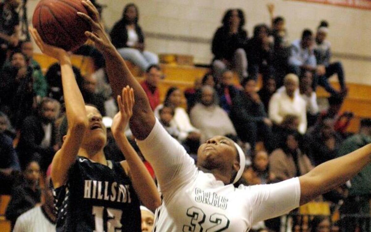 Hillside's Faith Blackstone (12) is defended by Tamia Hicks (32) of Southeast Raleigh on Monday.