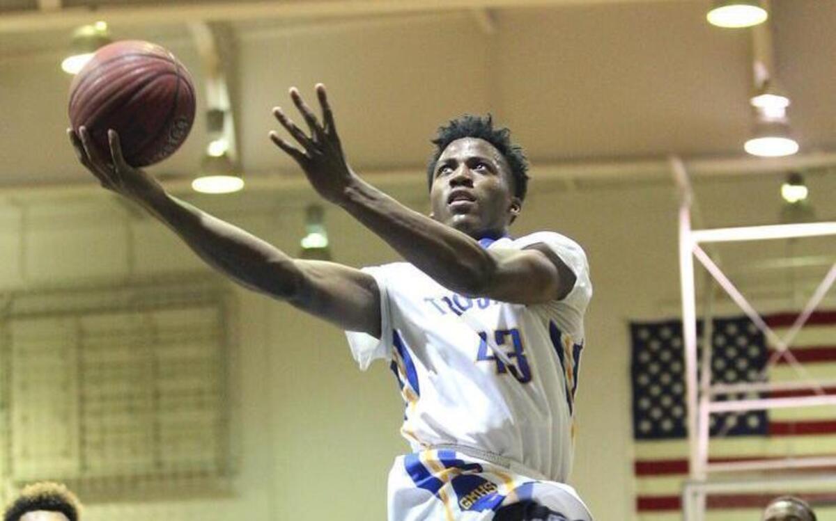 Garner's Andrew Abrom (43) drives the lane during the Garner Magnet Trojans high school basketball game with the Millbrook Wildcats in the fourth round 4A Boys Basketball Playoffs, Tuesday, March 1, 2016, in Garner, N.C.