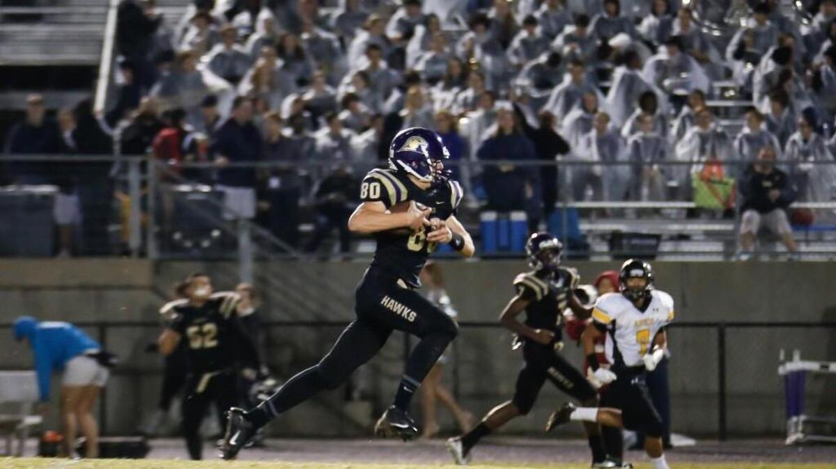 Holly Springs tight end Alex Luedeke takes a pass for a long touchdown against Apex last year.