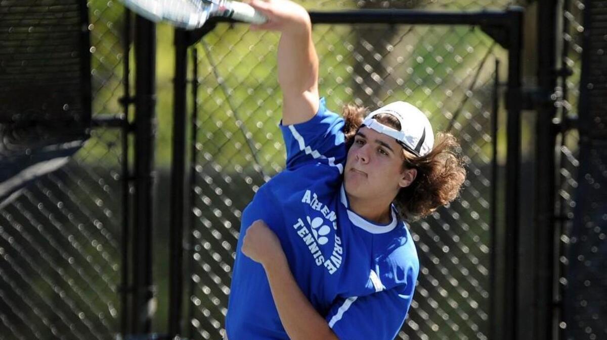 Athens Drive's Tyler Brogen serves during the boys tennis match against Fuquay-Varina, which took place in Raleigh on Monday, April 4, 2016.