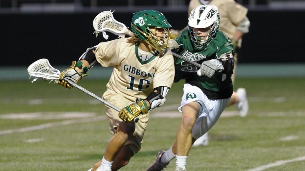 Durham Academy's Sam Petrucci (right) challenges Cardinal Gibbon's Jack Shelton (left) during the boys lacrosse game, which was played in Raleigh on Friday, March 4, 2015. Cardinal Gibbons won 16-7.