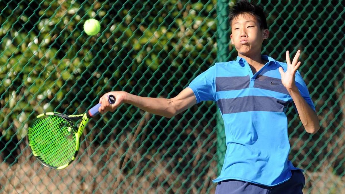 Panther Creek's Alex Kim returns the ball during the boys tennis match against Middle Creek, which took place in Cary on Monday, April 4, 2016.