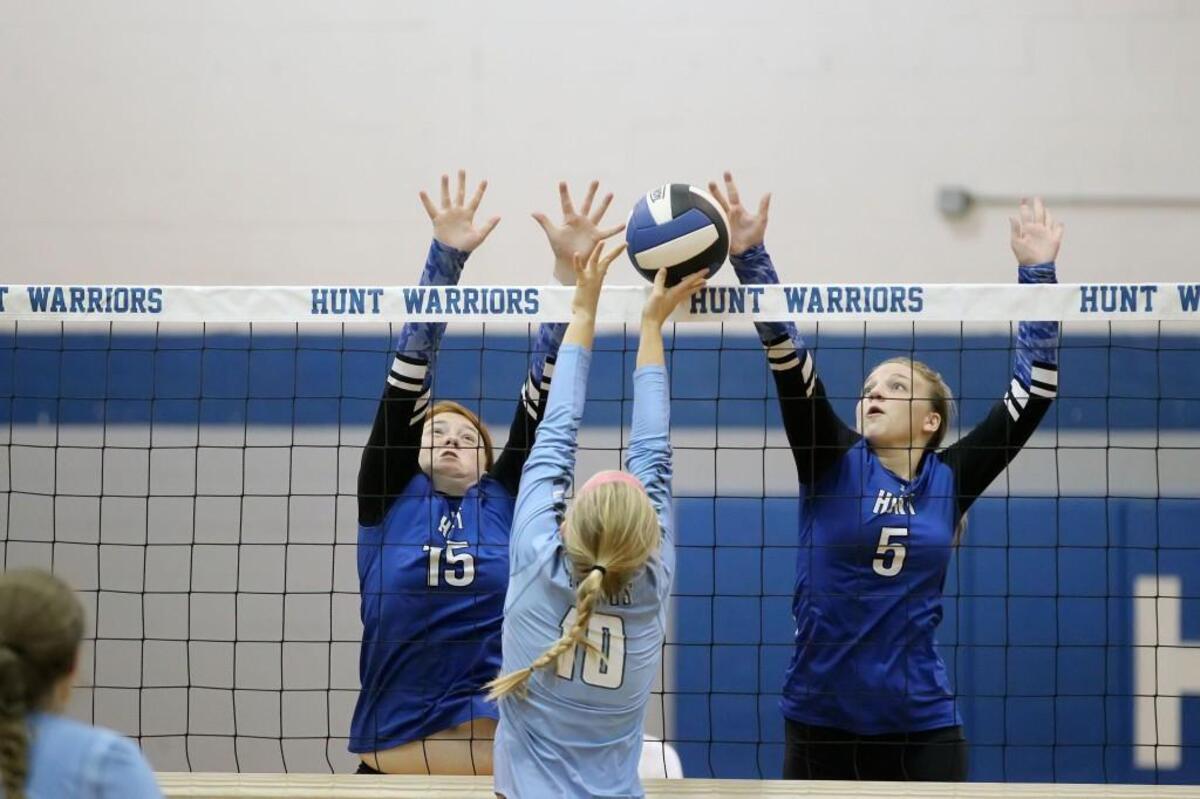 Hunt’s Michela Evans (15) and Carissa Parrott (5) blocks Union Pines’ Eliza Athans (10) during the Union Pines High School volleyball game against Hunt High School in Wilson, N.C. on Thursday, October 27, 2016.