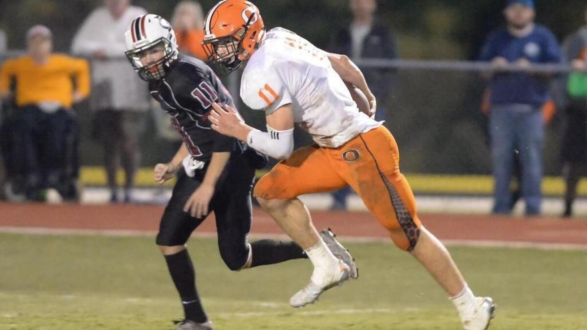 Payton Wilson, right, of Orange runs for a touchdown after intercepting a pass from Philip Berger, left, of Cedar Ridge. The Cedar Ridge Red Wolves played the Orange Panthers in a football game that took place in Hillsborough, N.C. on Friday, October 14, 2016. Orange won 42-3.