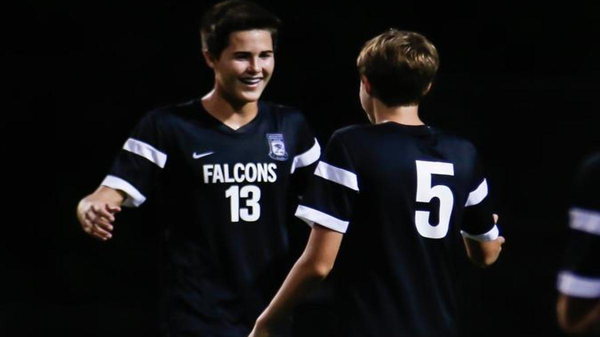 Green Hope’s Camden Holbrook, left, celebrates his winning goal on a penalty kick with Jacob Sciandra last season.