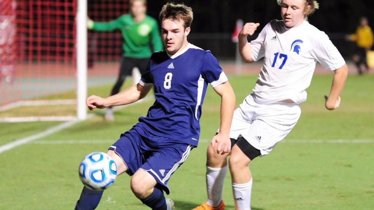 Franklin Academy’s Grant Lewis (8) controls the ball in front of Community School of Davidson’s Ausitn Timoney (17) during the NCHSAA 1A boys soccer championship game in 2015.