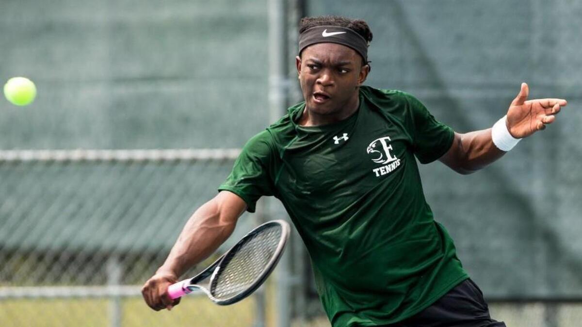 Enloe’s Mike Ogundele hits a shot during the Cap-8 tennis finals at Millbrook Exchange Park in Raleigh, N.C. on Thursday, April 27, 2017.
