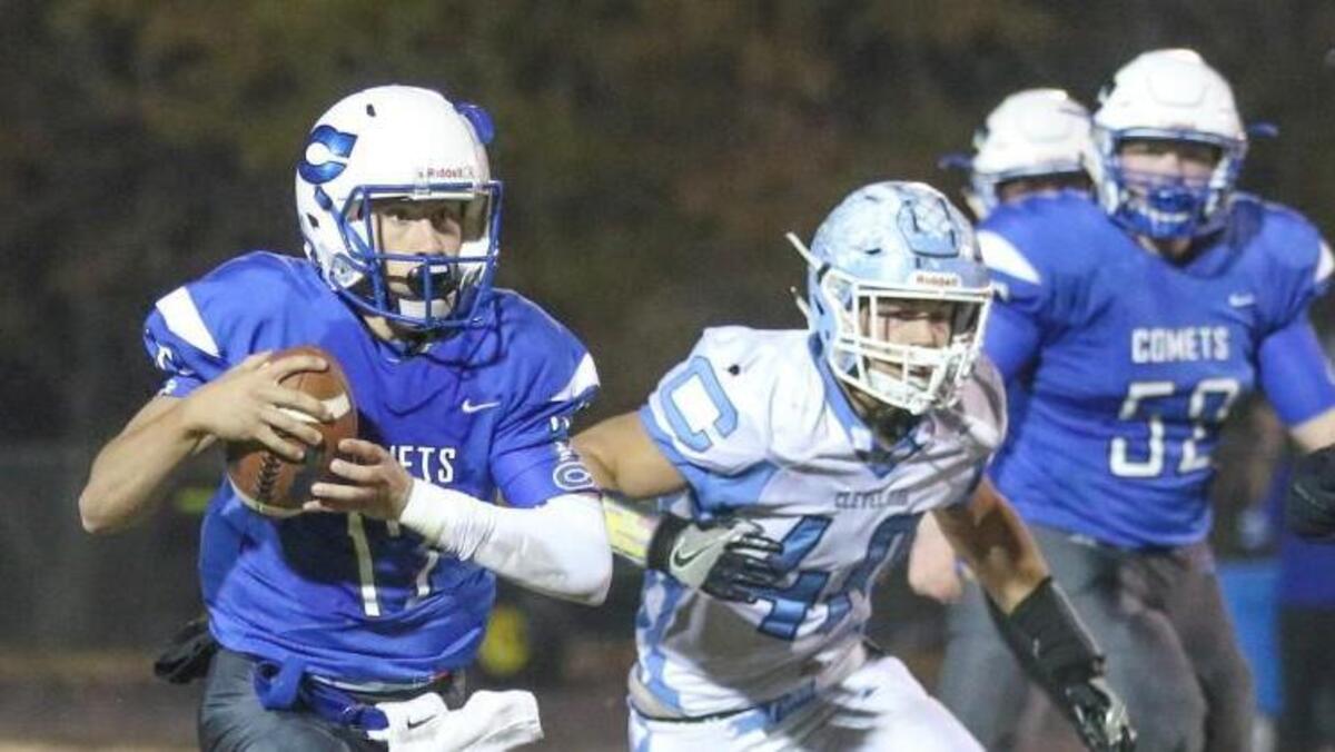 Clayton quarterback Austin Cagle (12) scrambles for a first down with 2 minutes left in the game that allows the Comets to run out the clock for the win. Coverage from the second round of the NCHSAA 3AA football playoffs between the Clayton High Comets and the Cleveland High Rams played in Clayton, N.C. on Friday, November 17, 2017.