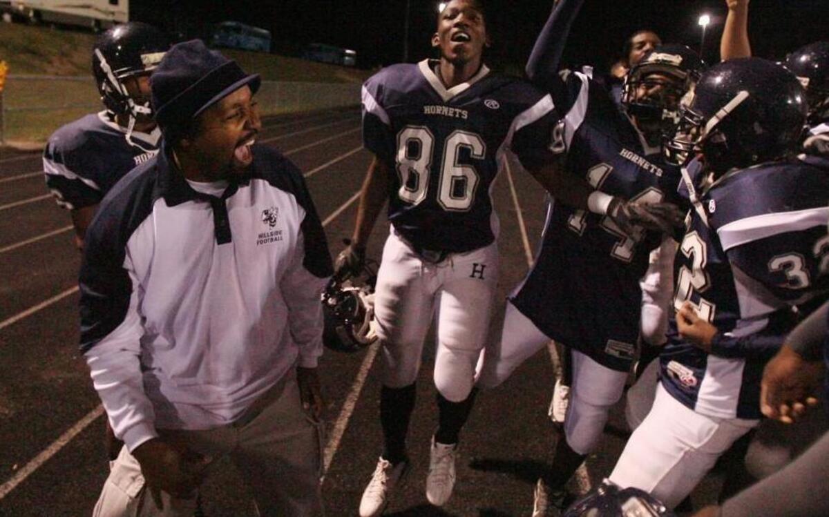 Hillside coach Ray Harrison celebrates with his team after they defeated Person High School 28-14 on Friday, November 2, 2007.