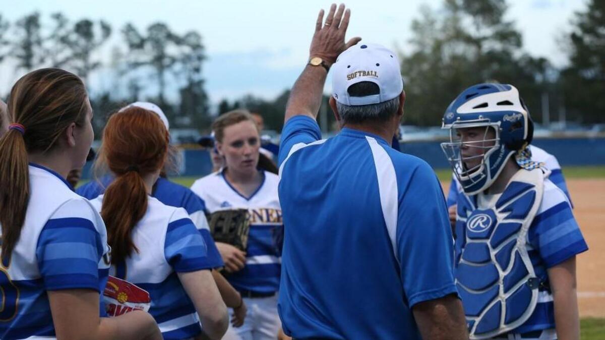 Garner coach Moe Barbour talks to his team during the Garner Trojans High School game against the East Wake Warriors High School , March 24, 2016, Garner, N.C. Garner won the game 7-5.