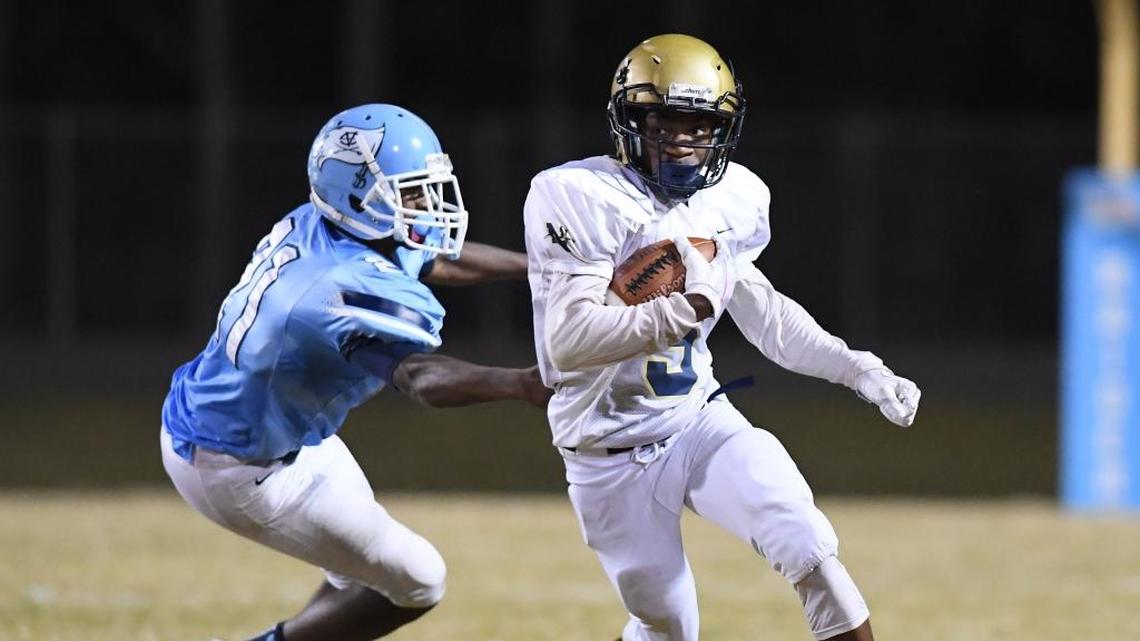 Brian Jordan, right, of Northern Vance carries the ball against Lorenz Evans, left, of Southern Vance. The Northern Vance Vikings visited the Southern Vance Raiders in a high school football game on Nov. 3, 2017.