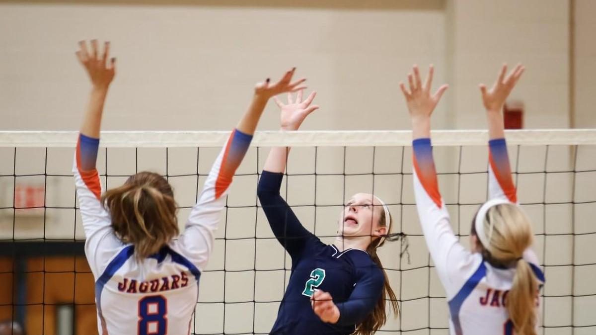 Leesville Road’s Sarah Gasper (2) shoots past the defense of Athens Drive's Elisabeth Smith (8) and Raquel Rooney (6) during Athens Drive's volleyball match at Leesville Road on Saturday, October 23, 2015. Leesville Road won the game 3-1.