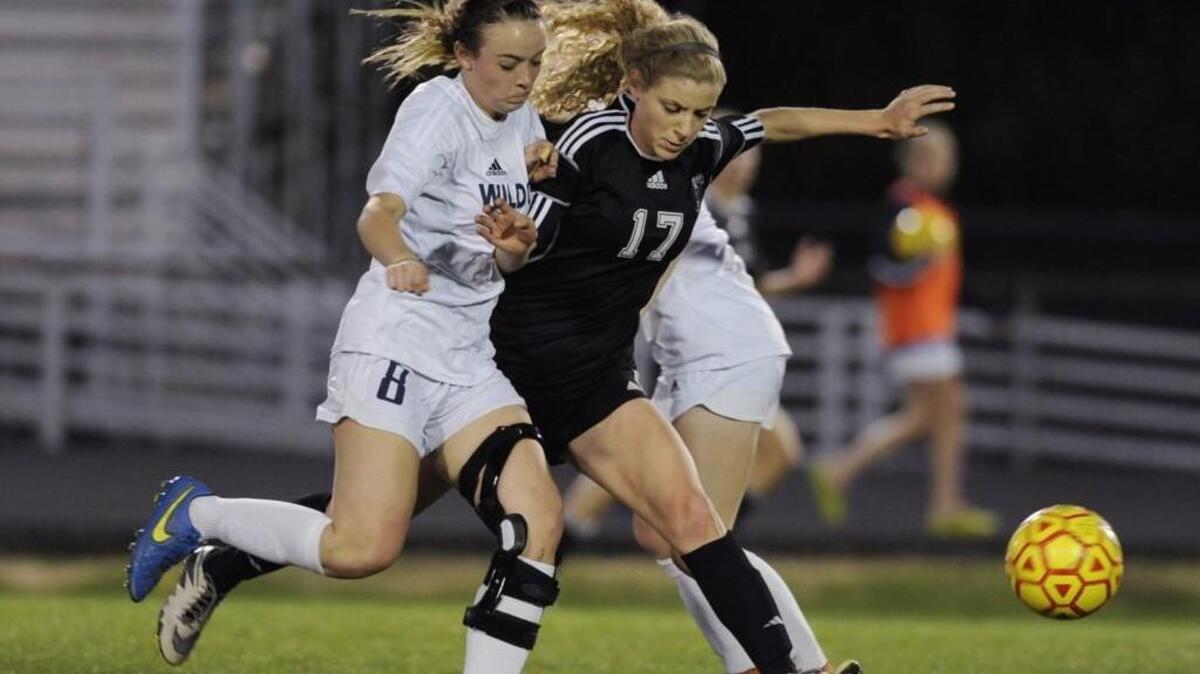 Millbrook's Hayden Trueheart (8) and Wakefield's Morgan Nanni (17) go after the ball in Raleigh, N.C. on Wednesday, March 23, 2016. Millbrook won 1-0.