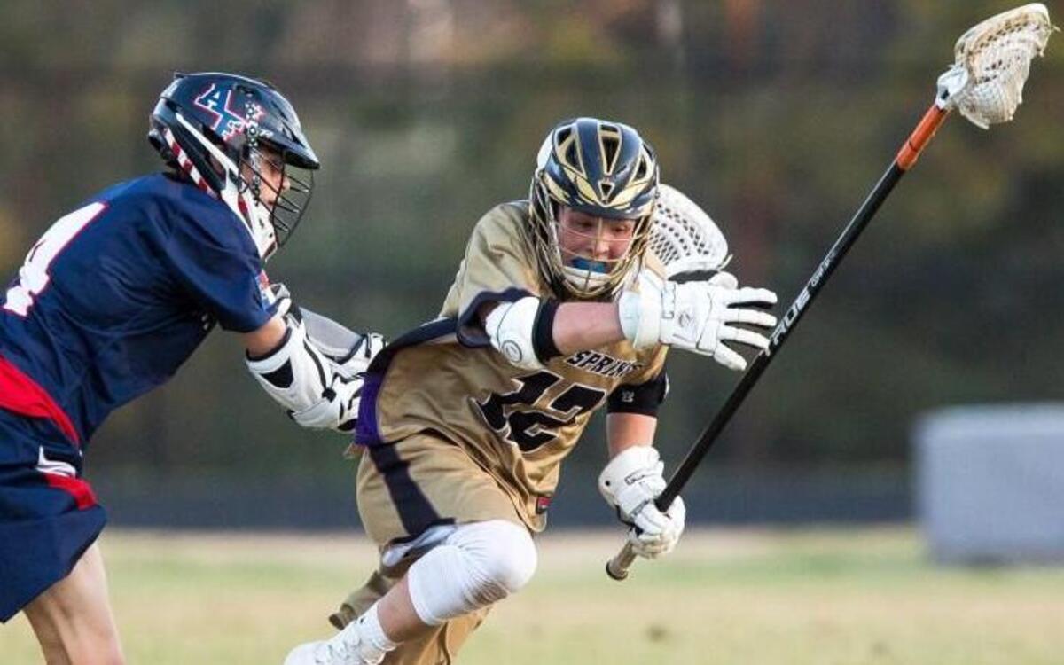 Holly Springs’ Noah Arneson (12) is shoved by Apex Friendship's Hunter Vauhan (4) during a high school lacrosse game in Holly Springs, N.C. on Friday, Mar. 24, 2017.