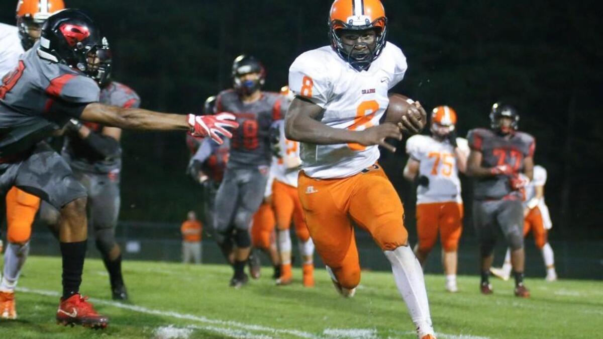 Orange back Marvante Beasley (8) takes a run outside as Southern defender Ryan McLamb, left, stretches out an arm during Orange's football game at Southern Durham on Friday, September 23, 2016.