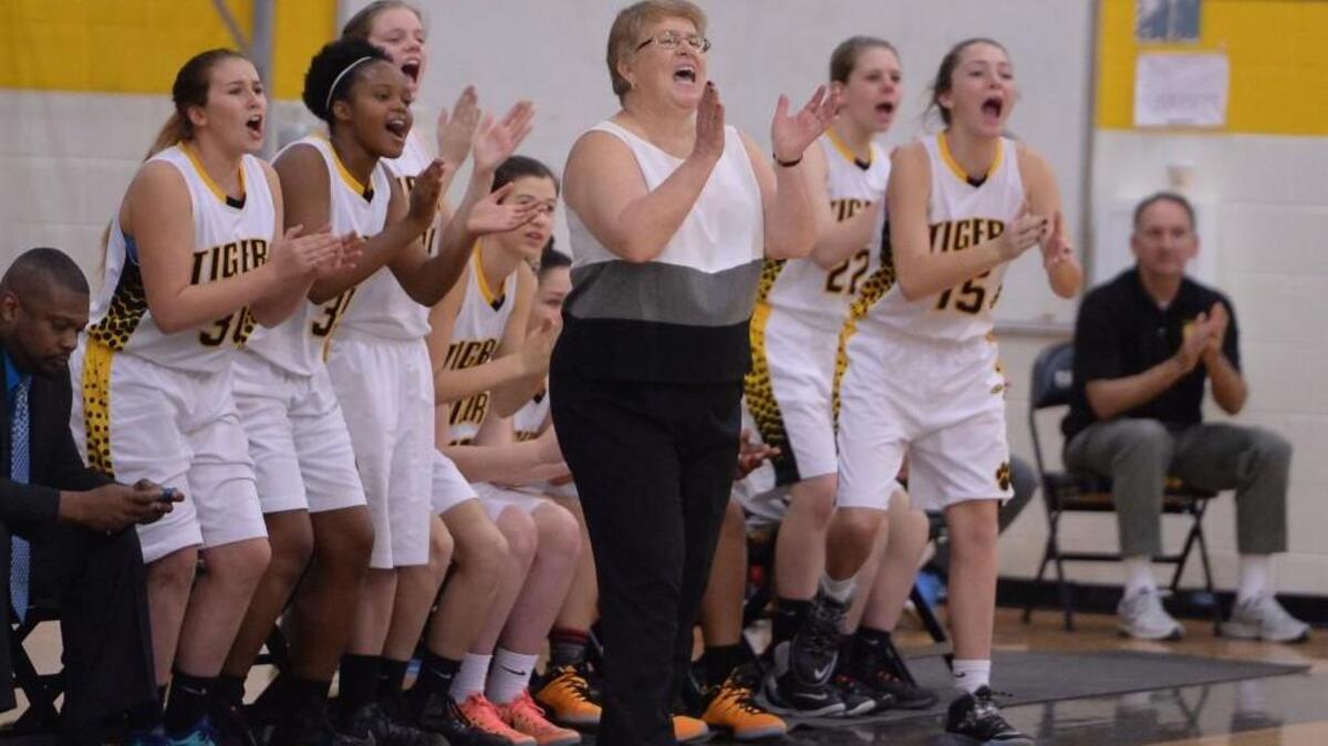 Sherry Norris, center, is retiring after the season after 40 years as Chapel Hill’s girls basketball coach.