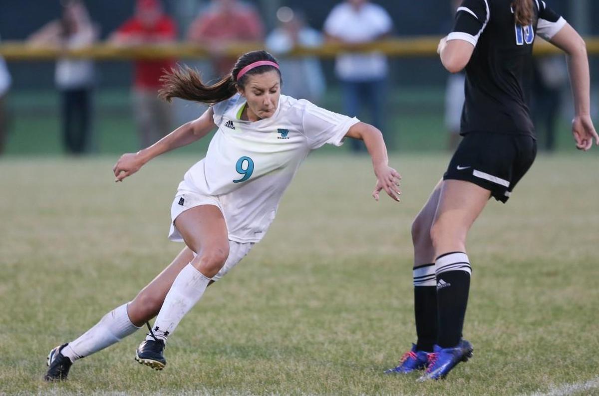 West Johnston's Robin Pollard (9) makes move to get around Clayton defender Peyton Doyle (10). Coverage from the girls soccer between the Clayton Comets and the West Johnston Wildcats played in Benson, N.C. on Wednesday, April 26, 2017. Clayton defeated West Johnston 3-2 in overtime to clinch the Greater Neuse River regular season championship.