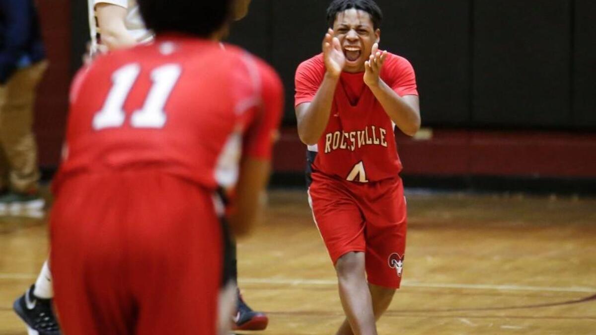 Rolesville's Jaylin Parker (4) celebrates a turnover in the final moments of the game with Ricky Clemons (11) during the Rolesville boys' basketball game at Harnett Central on Friday, February 5, 2016. Rolesville won 55-51.