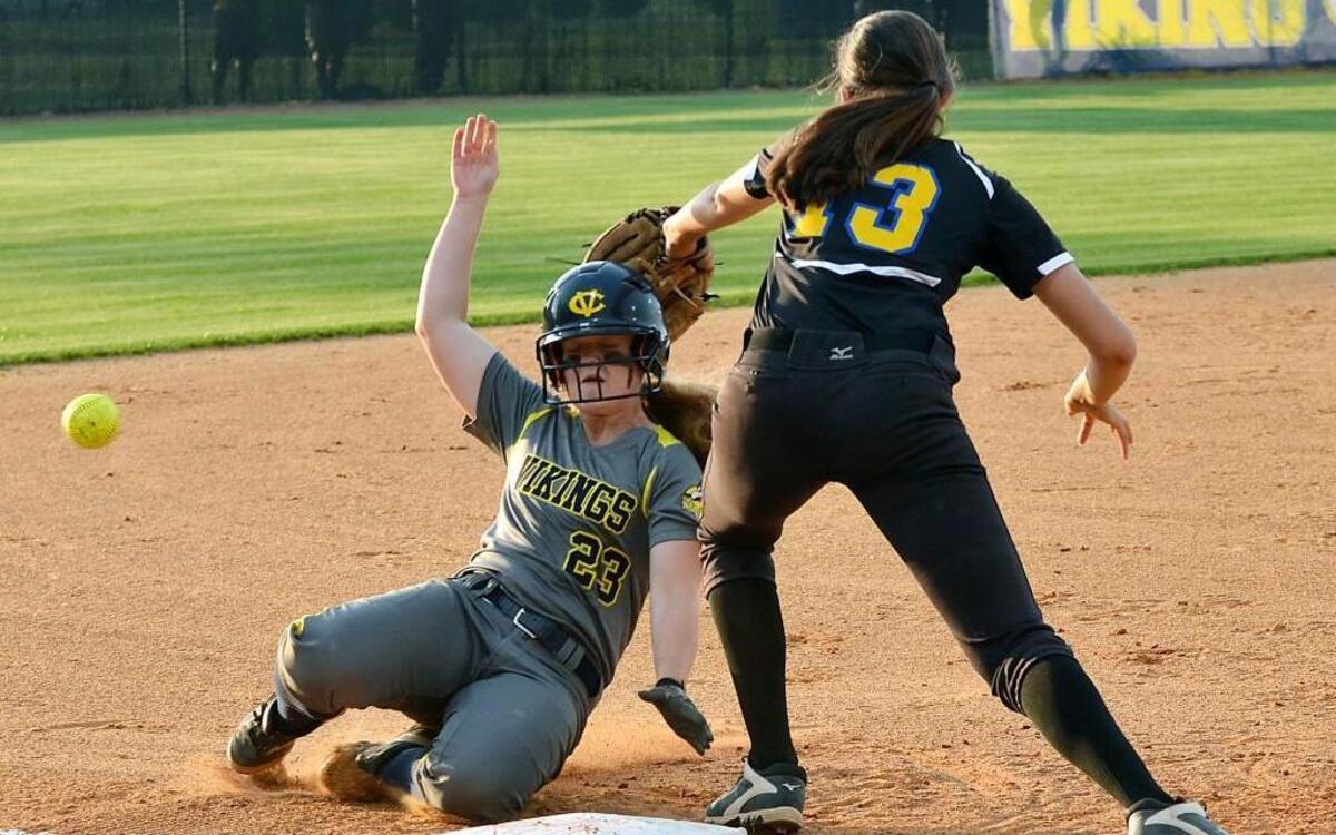 Conley’s Lexi Phillips (23) slides into third base as the ball gets away from East Wake’s McKenzie Moore (13) in their first-round N.C. High School Athletic Association 4A softball playoff game in Greenville, N.C. Tuesday, May 10, 2016.