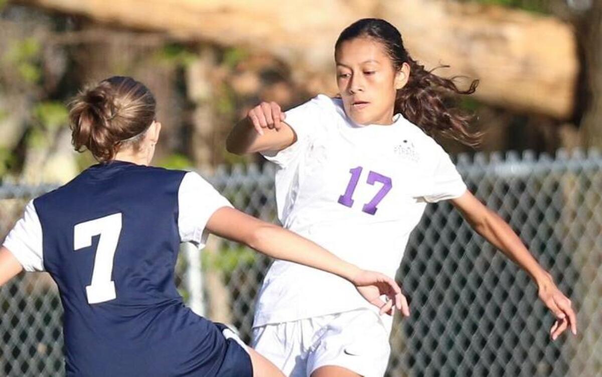 Corinth Holders’ Carolina Solis (17) maneuvers past Smithfield-Selma defender Natalie Sabiston (7) on her way to goal. The Corinth Holders Pirates and the Smithfield-Selma Spartans played in Archer Lodge, N.C. on Thursday, April 14, 2016. Corinth Holders defeated Smithfield-Selma 5-1.