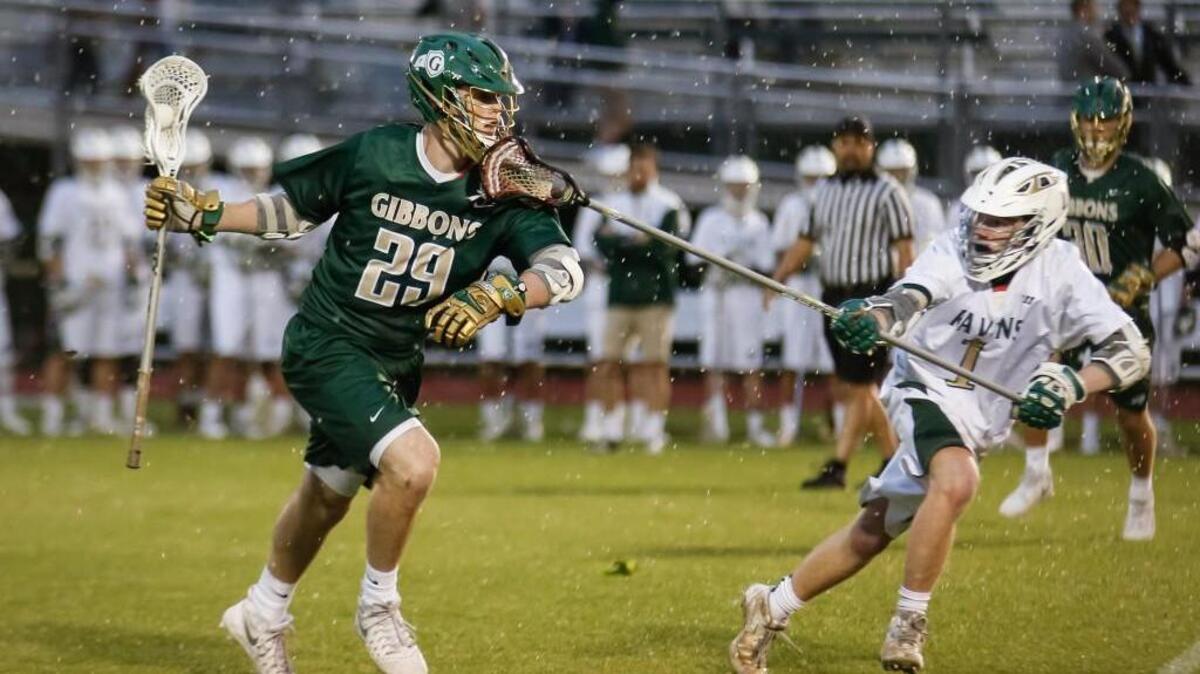Cardinal Gibbons' Kevin Barry (29) penetrates with the ball while Ravenscroft's Nolan Irey (1) defends during Cardinal Gibbons' boys lacrosse match at Ravenscroft on Thursday, April 7, 2016. Cardinal Gibbons won the match 10-6 on the strength of Barry's 5 goals.