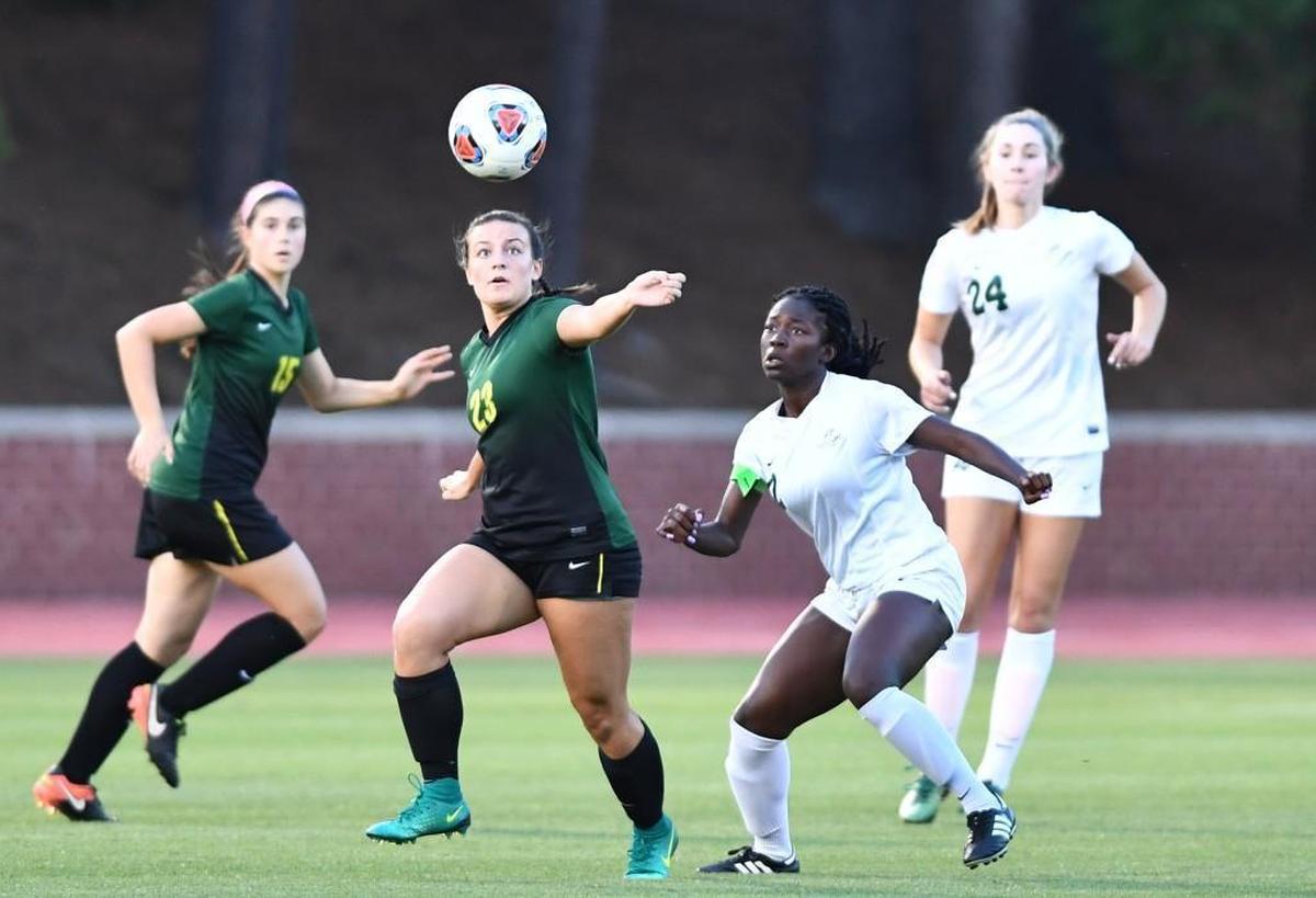 Reni Taiwo (2) of Cardinal Gibbons follows the ball in the air as she prepares to defend. The Cardinal Gibbons Crusaders played the West Forsyth Titans in a soccer game that took place in Raleigh, N.C. on Saturday, May 27 2017. West Forsyth won 4-3.