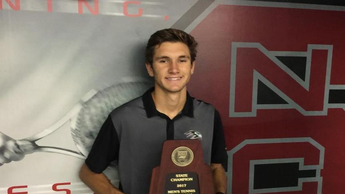 Green Hope's Ben Wayand poses with the 4A singles championship trophy at the NCHSAA individual boys tennis championships at N.C. State on May 13, 2017.