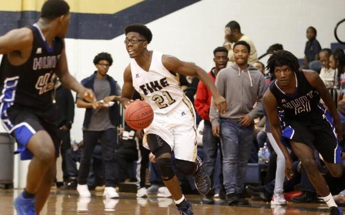 Fike's Samson Strickland (21) dribbles the ball up the court as Hunt's Floyd Evans (21) trails during the Hunt High School boy's basketball game against Fike High School High School in Wilson, N.C. on Tuesday, January 24, 2017.