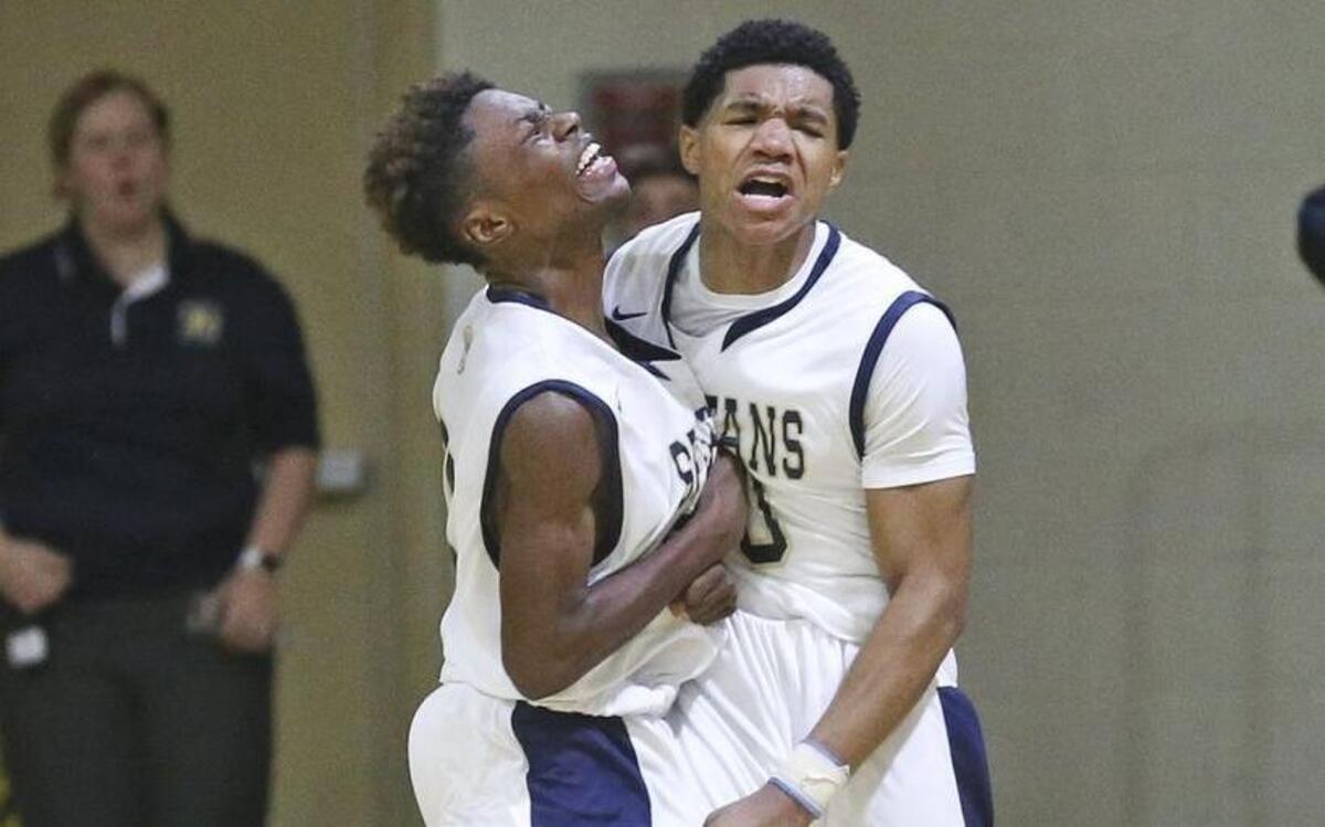 Smithfield-Selma's Kavon Ward (right) celebrates with Anthony Council after draining the winning 3-pointer as the clock ran out to pull out the Spartan victory.