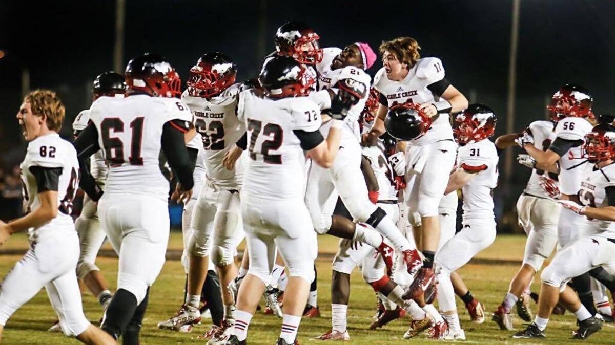 Middle Creek’s team members, from left, Caleb Woody (72), Riley Frederiksen (9), Darian Fogg (21) and Andrew Ihle (11), celebrate after kicking the winning overtime field goal during Middle Creek's football game at Fuquay-Varina on Friday, October 23, 2015. Middle Creek won the game 17-14 in overtime.