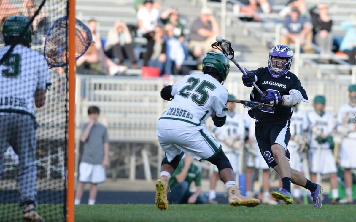 Greyson Magee (2) of Carrboro takes a shot on goal against Christian Lassiter (25) and Eric Franklin (9) of Northwood. The Northwood Chargers played the Carrboro Jaguars in a boys lacrosse game that took place in Pittsboro, N.C. on Wednesday, April 13, 2016. Carrboro won 20-8.