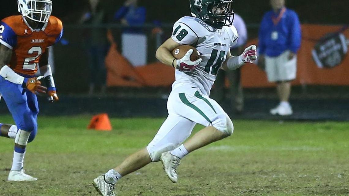 Green Hope’s Aidan Callahan, right, runs back a punt return against Athens Drive on Nov. 6, 2015.