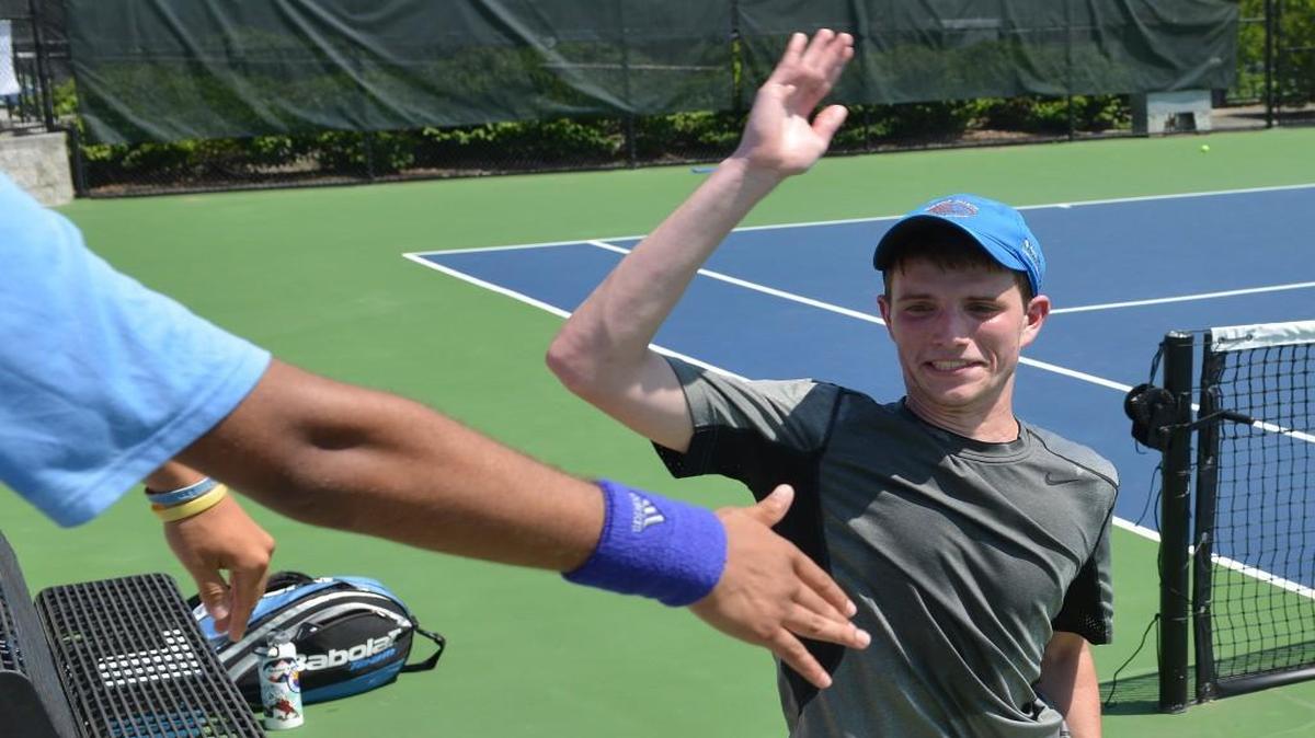Nick Kuzma of North Carolina School of Science and Math celebrates with his teammates after winning his game against Cameron Wilson of Brevard. The North Carolina Science & Math Unicorns played the Brevard Blue Devils in a boys tennis match that took place in Burlington, N.C. on Saturday, May 20 2017. North Carolina School of Science and Math won 5-0.
