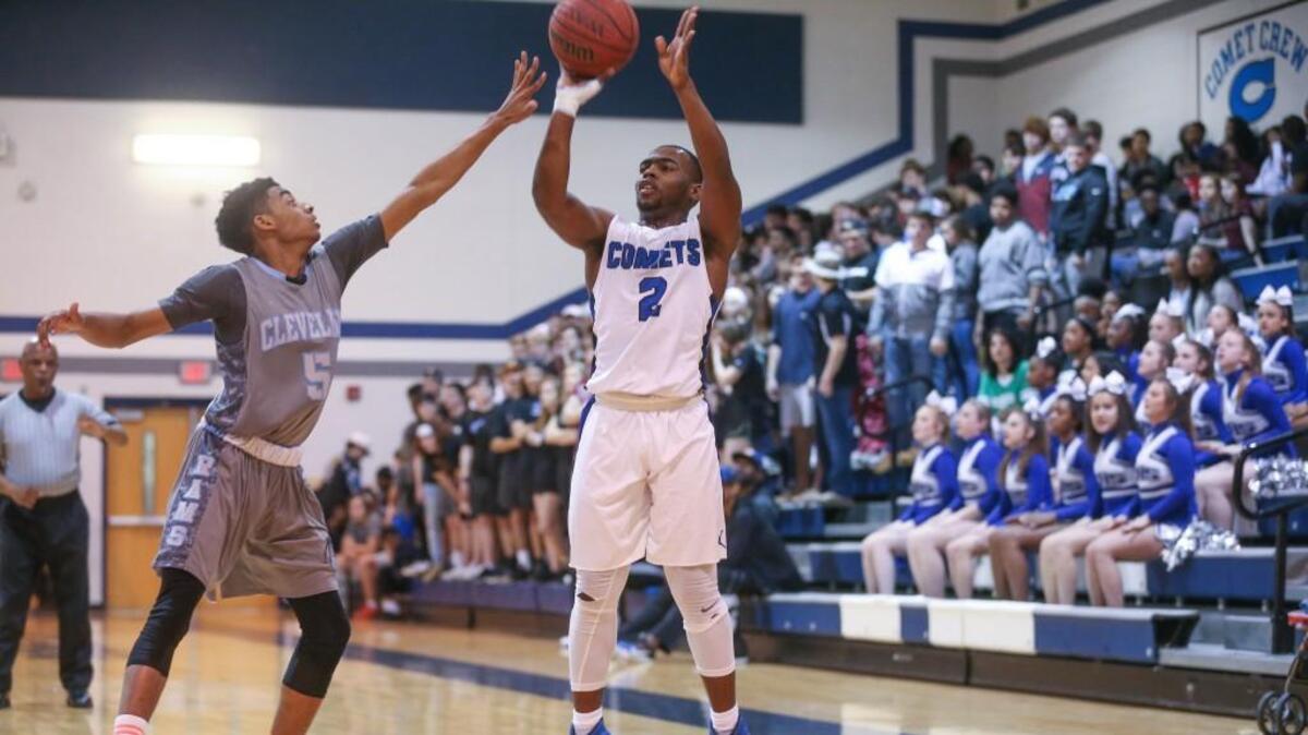 Clayton's Macaleb Robertson (2) starts off the Clayton scoring with a three pointer over Cleveland's Josh Marlow (5). The East Wake Warriors and the Clayton Comets girls and Clayton Comets and the Cleveland Rams played in the Greater Neuse River 3A Conference basketball tournament championships on Friday, February 16, 2018 in Clayton, N.C..