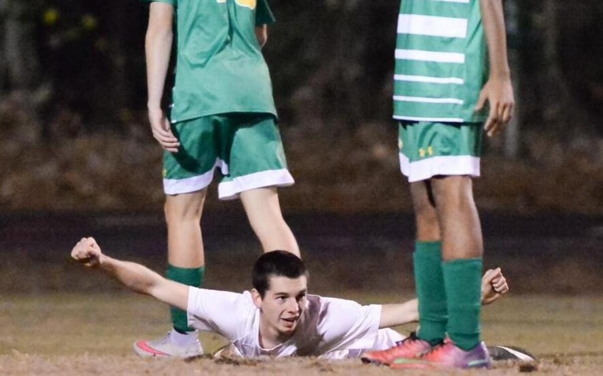 Payton Jackson, center, of Lee County celebrates after scoring the winning goal. The Eastern Alamance Eagles played the Lee County Yellow Jackets in Sanford, N.C. on Tuesday, November 17, 2015. Lee County won 1-0.