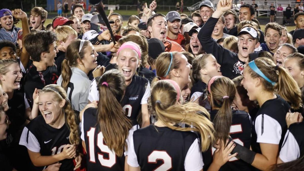The Middle Creek team are surrounded by their celebrating fans following Middle Creek’s girls soccer game at Athens Drive on Tuesday, May 24, 2016. Middle Creek won the game 4-1 and will play in the State Championship.