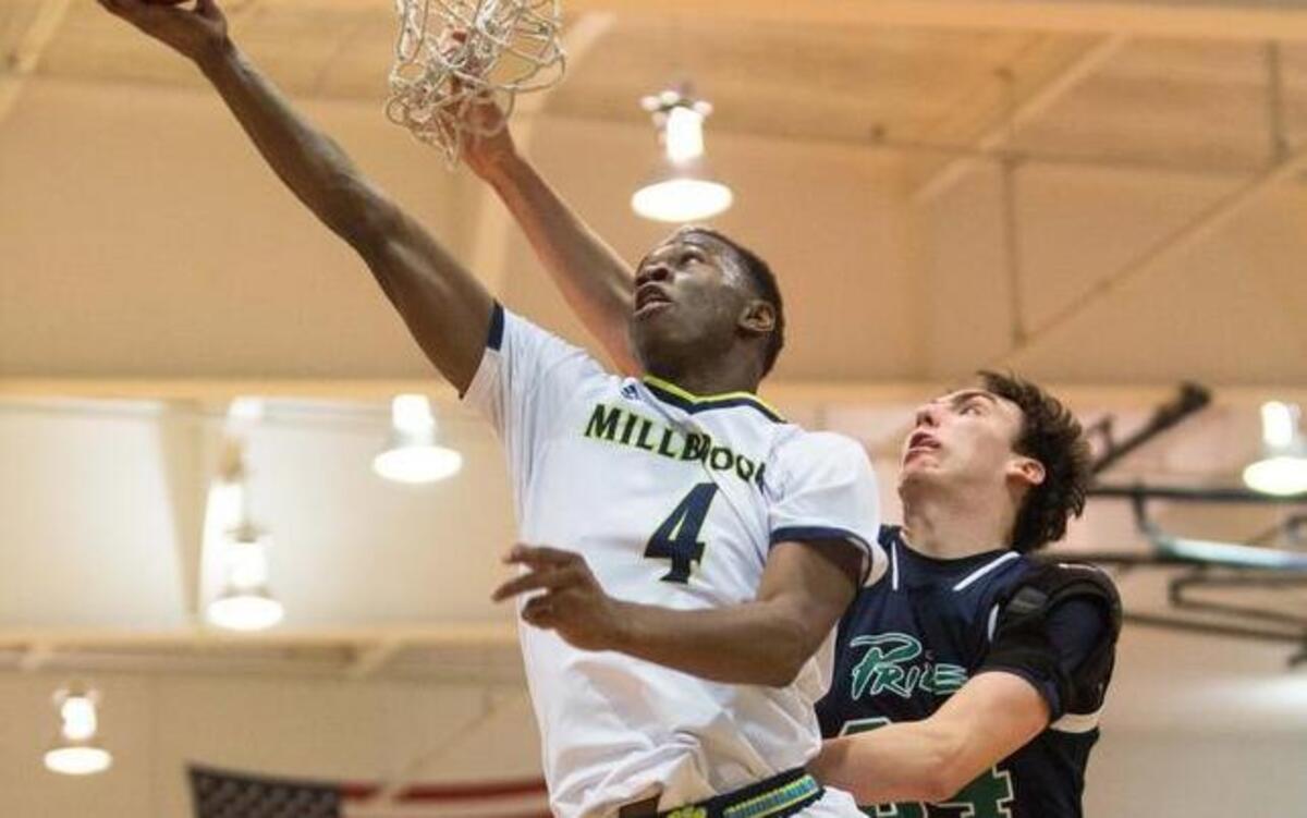 Millbrook’s Faison Brock goes up for a shot as Leesville’s Eric Scollard (34) defends during a high school basketball game in Raleigh, N.C. on Thursday, Jan. 21, 2016. Millbrook won 78-52.