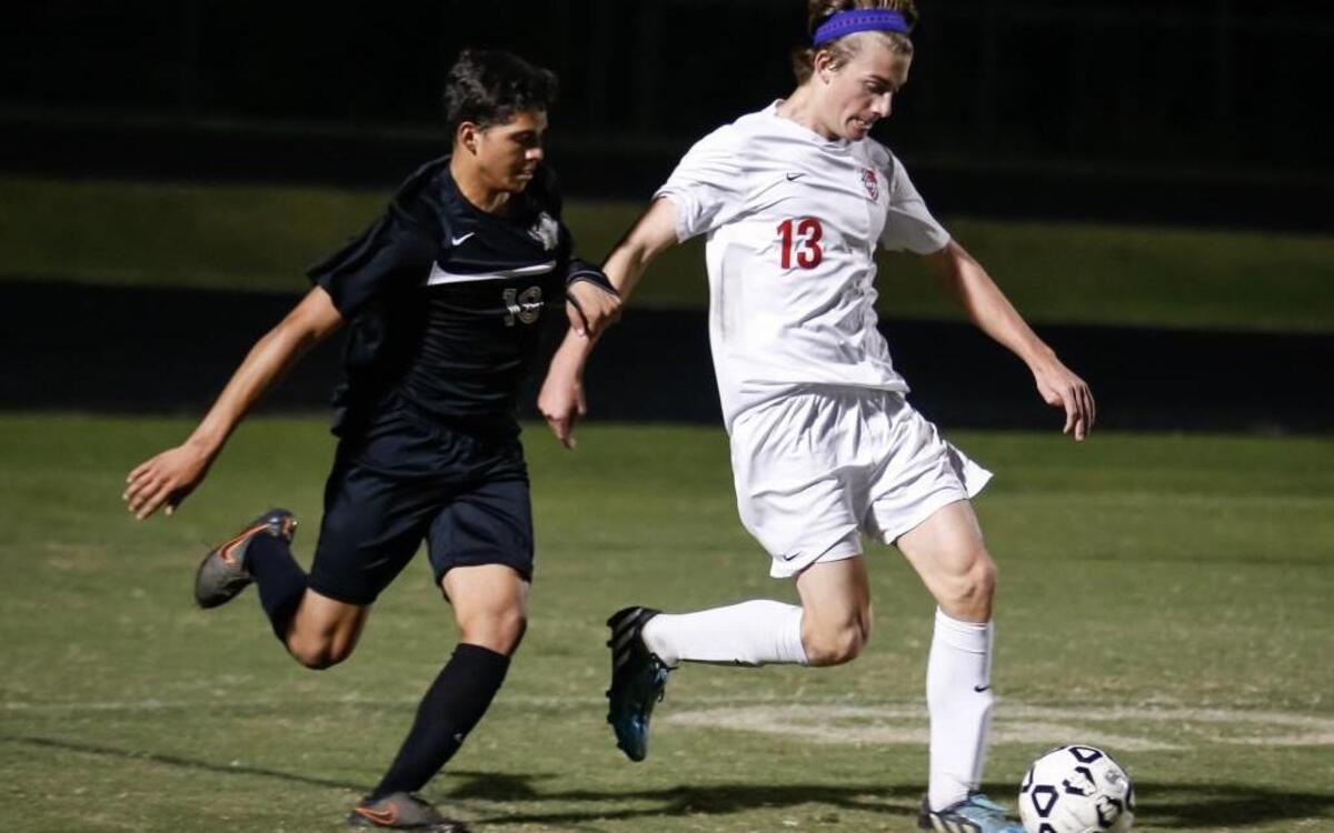 
Middle Creek’s Rhys Borror (13) fights off Holly Springs' Eddy Zuniga (18) during Holly Springs' soccer match at Middle Creek on Wednesday, October 14, 2015. Middle Creek won the game 4-0.
