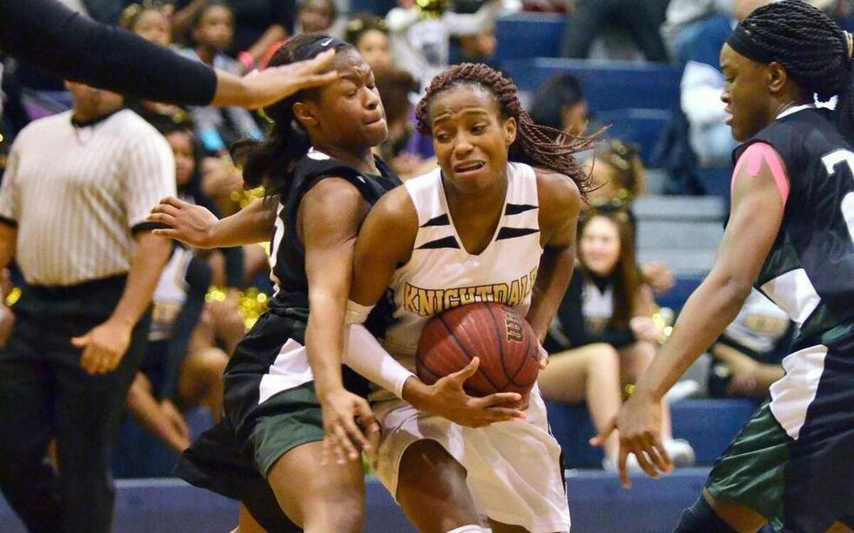 Knightdale point guard Mikaya Wilson is sandwiched between the defense of Southeast Raleigh junior Makayla Sutton (left) and senior Kia Abrams during their Greater Neuse River Conference game in Knightdale, N.C. Tuesday, Feb. 2, 2016.