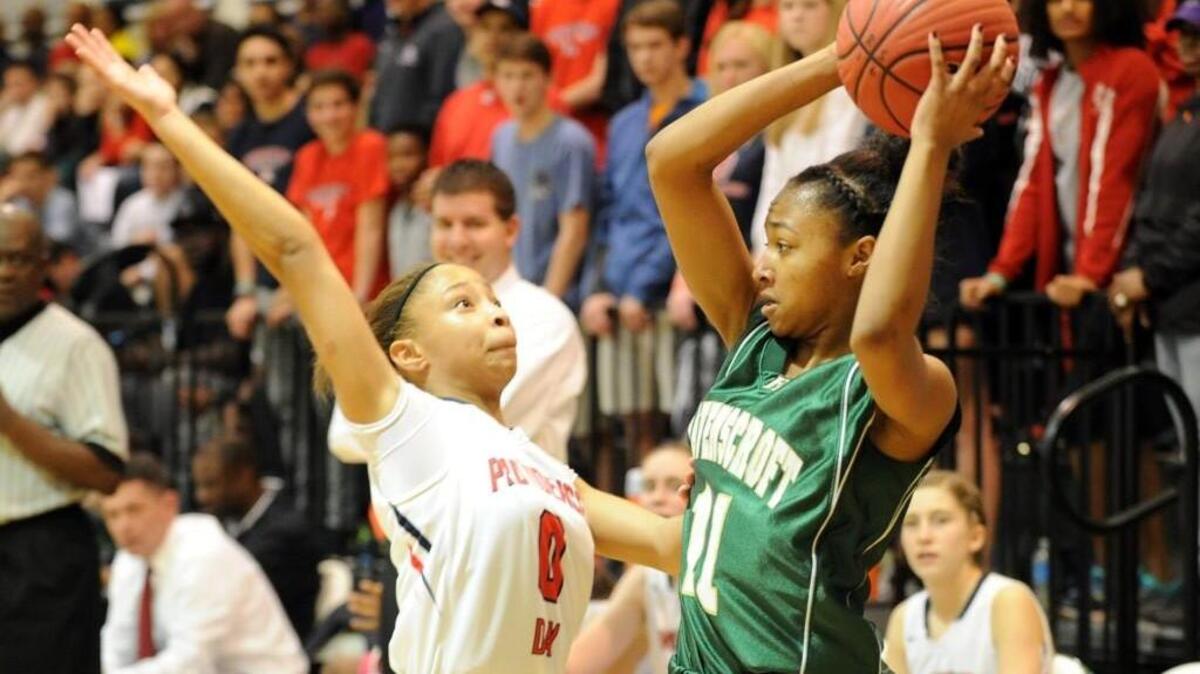 Providence Day's Kennedy Boyd (0) puts pressure on Ravenscroft's Madison Taylor (11) during the NCISAA 3A girls basketball championship game, which was played in Raleigh on Saturday, February 20, 2016. Providence Day won 42-21.