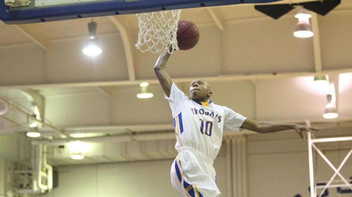 Garner’s Marque Maultsby (10) goes in for the dunk during a first round basketball playoff game between the Garner and Wilmington Ashley on Tuesday night.