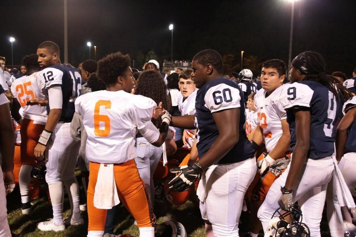 Players from Orange and Hillside shared a prayer and words of encouragement together after Orange running back Marvante Beasley was injured on the first play from scrimmage in the third quarter on Oct. 13, 2017. Beasley was moving his arms and legs as he was taken to an ambulance for further evaluation.