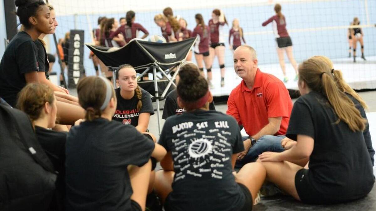 
Rolesville head coach, Brian Harris, second from right, instructs his players before a scrimmage against the Chapel Hill Tigers at the North Carolina Volleyball Academy in Durham, N.C. on Saturday, August 8, 2015.
