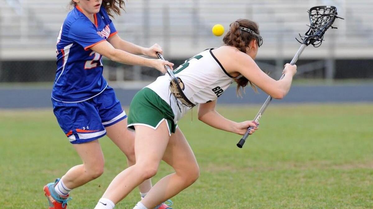 Athens Drive's Erin Kenedy (left) forces a turnover by Green Hope's Maddie McKinley game on April 7, 2015.