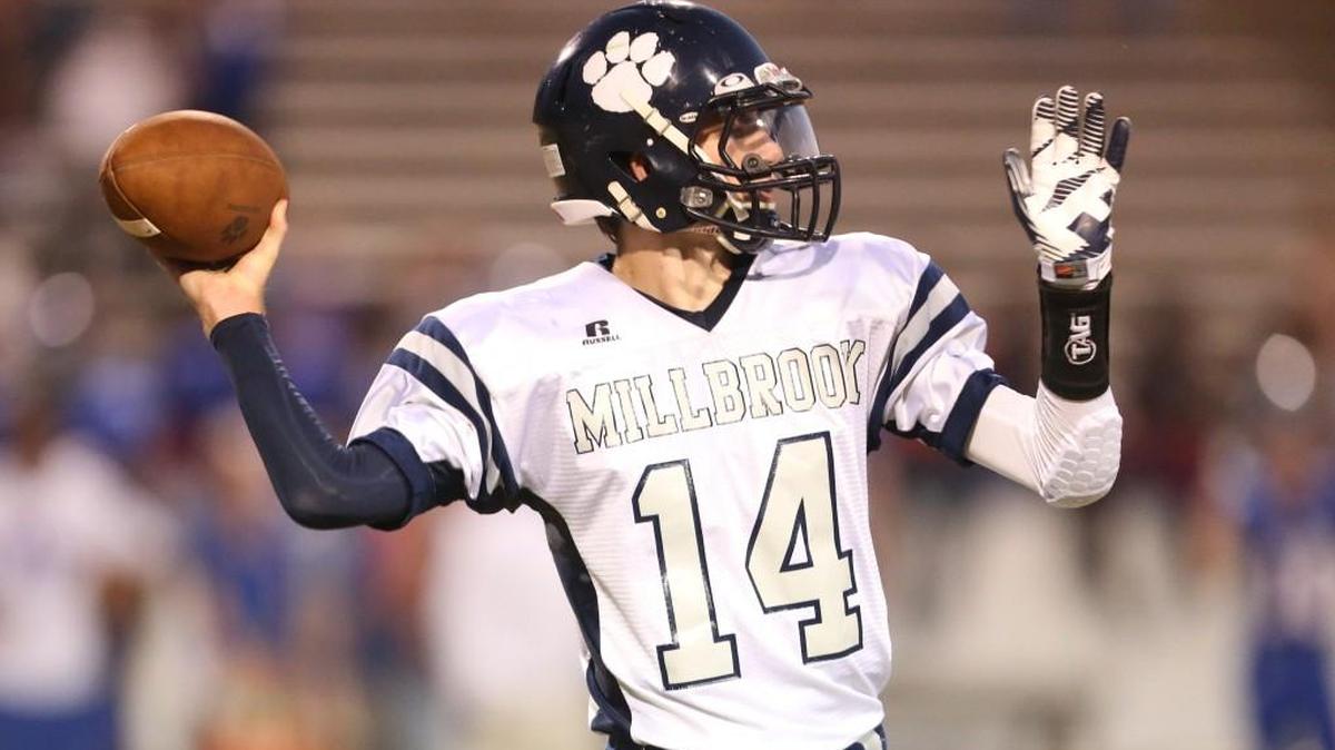 
Millbrook’s Reid Herring (14) looks for a receiver downfield and scores a touchdown during Millbrook’s football game against Wake Forest High School, Thursday, October 04, 2013 in Wake Forest, NC.
