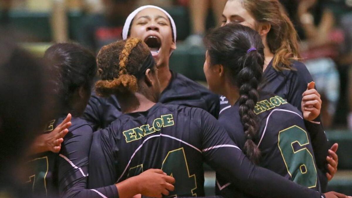 Enloe's Jackya Moore (center) reacts to the match point as the Eagles come away with victory. Coverage from the prep volleyball game between the Enloe Eagles and the Southeast Raleigh Bulldogs played in Raleigh, N.C. on Thursday, August 18, 2016. Enloe defeated Southeast Raleigh 3-2.