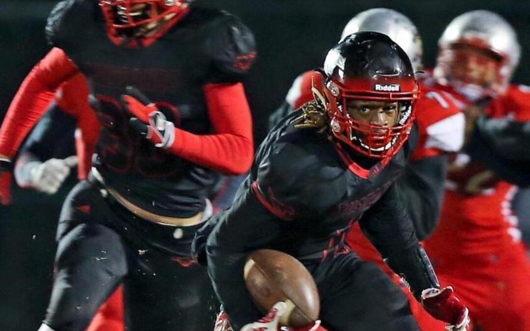 Middle Creek's Johnathan Spencer (1) runs back a punt for 91 yards late in the second quarter to set up the first Mustang score. Coverage from the Eastern Regional 4AA NCHSAA Football Championship game between the Middle Creek Mustangs and the Greensboro Page Pirates played in Apex, N.C. on Friday, December 04, 2015. Greensboro Page leads at the half 21-10.