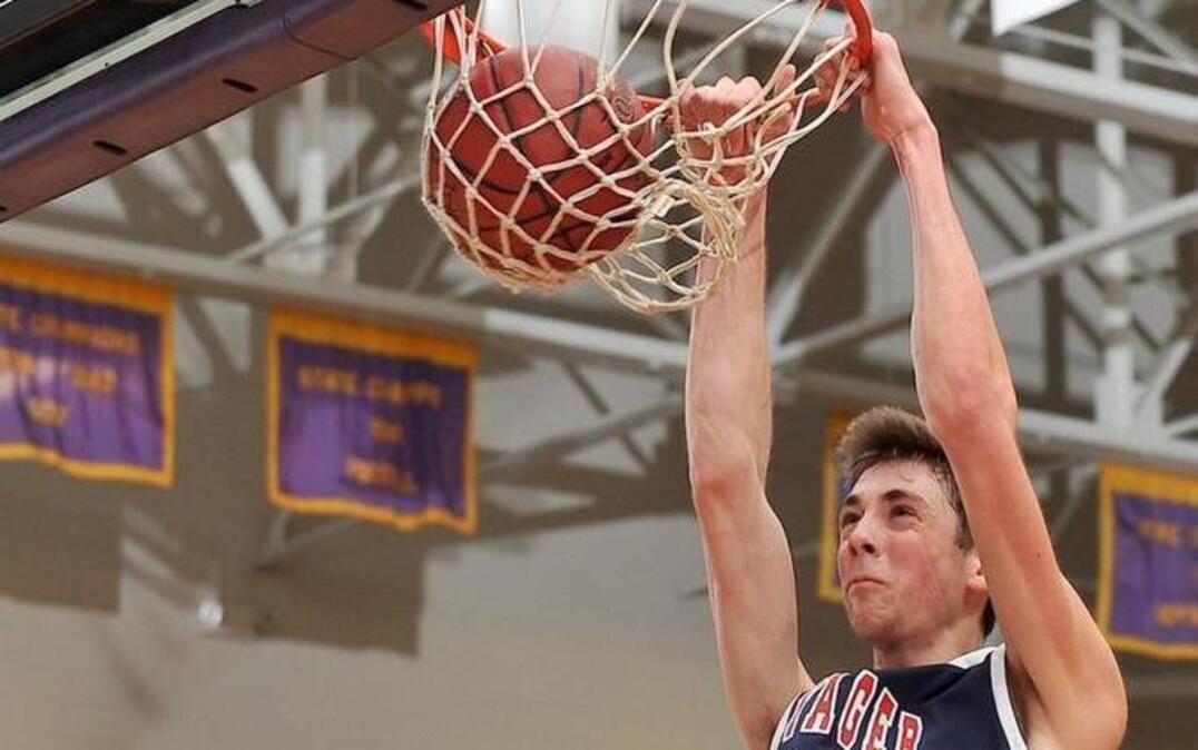 Voyager Academy’s Jay Huff (30) makes the dunk over Apex's Eric Fox during the first half.
