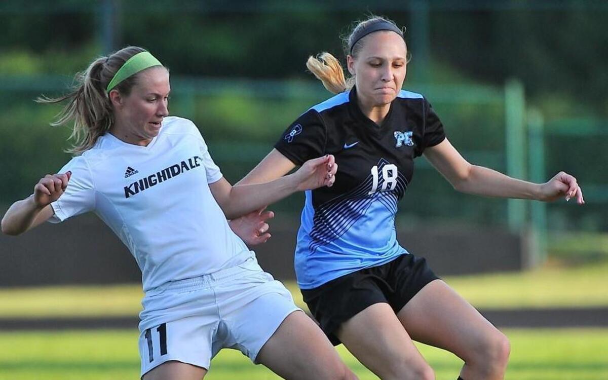 Knightdale's Tori Leech (11) challenges Panther Creek's Sarah Barnes (18) for the ball. The Knightdale Knights took on the Panther Creek Catamounts in a second round game of the NCHSAA 4A playoffs in Knightdale, N.C. on May 13, 2016. Panther Creek wins 3-1.